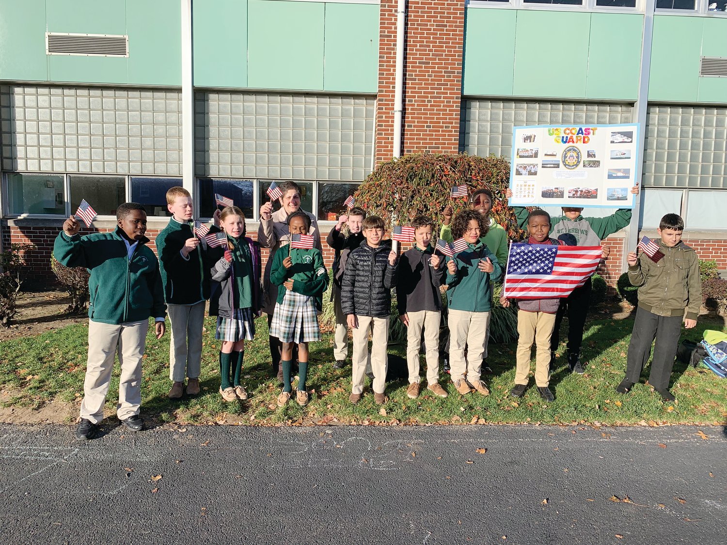 On November 10, students from Saint Teresa School in Pawtucket paid special tribute to the American veterans who have so heroically defended and served the country. Middle school students formed an honor guard to greet each student and parent as they arrived at school this morning. For the rest of the day students made ornaments for a veterans’ group and for the month of November the school community will collect warm clothing and food for veterans.